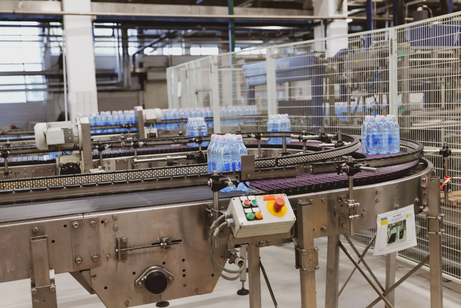 Bottled goods moving through an industrial production line